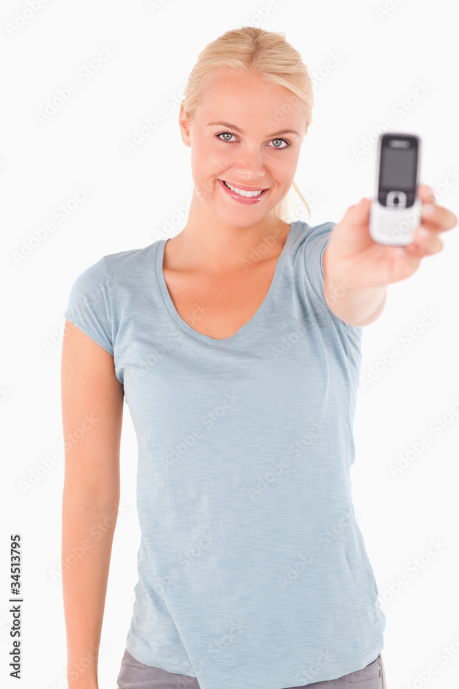 Smiling cute woman showing a phone Smiling cute woman showing a phone
