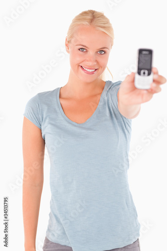 Smiling cute woman showing a phone