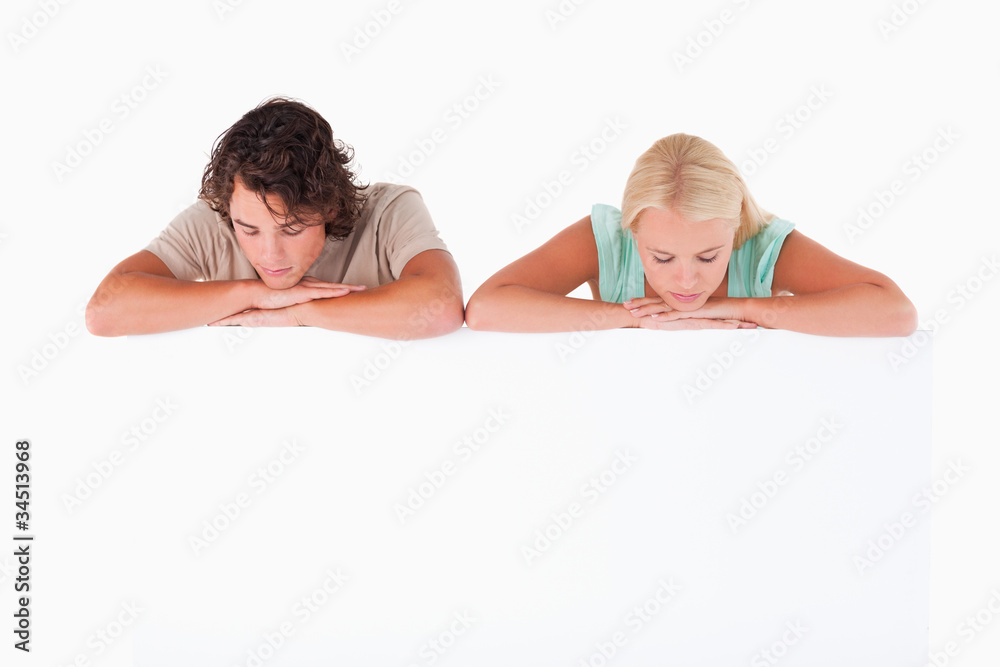 Couple leaning on a whiteboard Couple leaning on a whiteboard