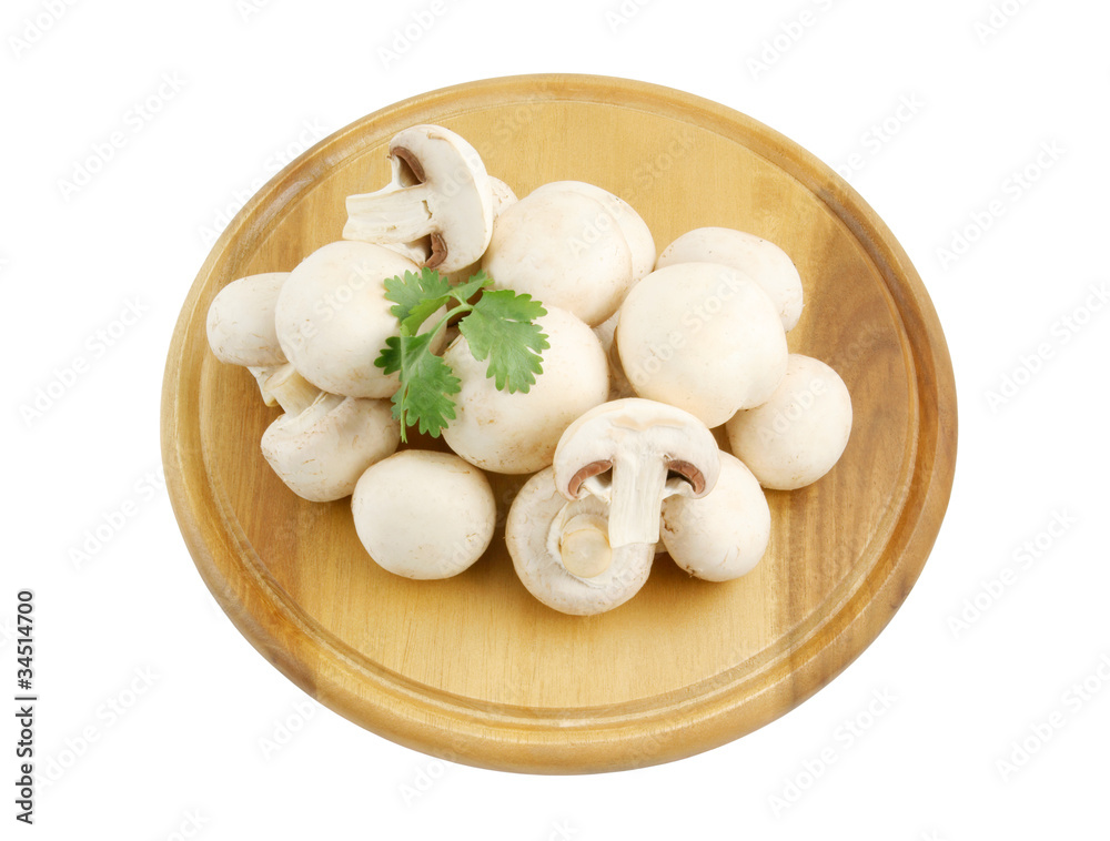 Fresh mushrooms and parsley on wooden cutting board isolated Fresh mushrooms and parsley on wooden cutting board isolated