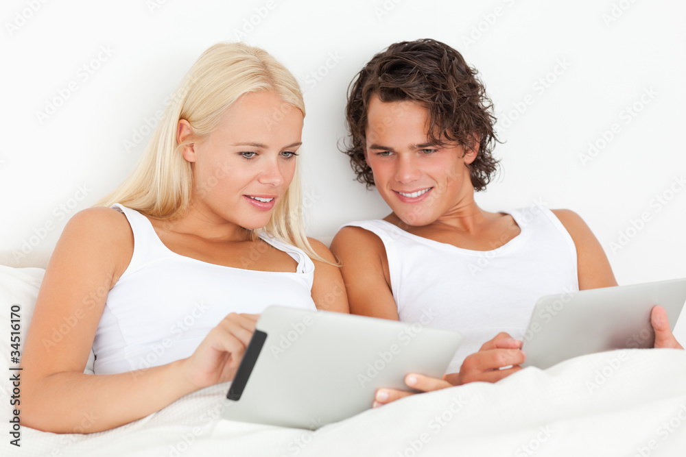 Gorgeous couple using tablet computers Gorgeous couple using tablet computers