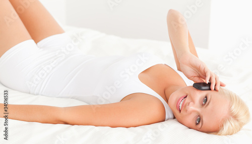 Woman lying on her back on the phone