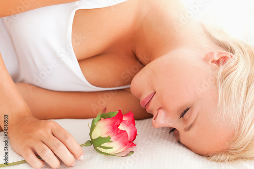Close up of a calm woman with a flower