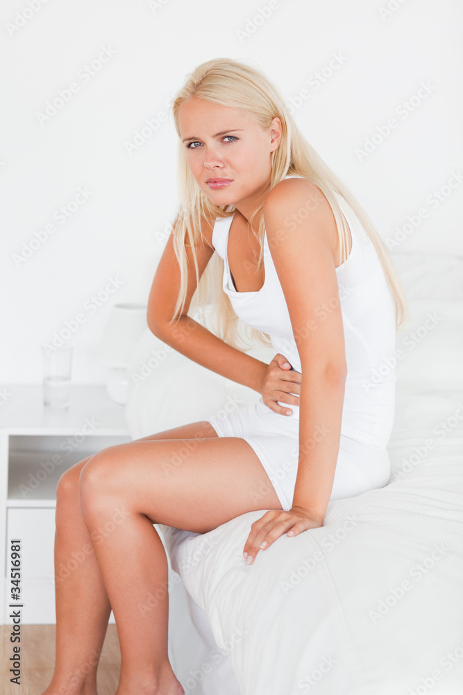 Portrait of a sick woman having a stomachache Portrait of a sick woman having a stomachache