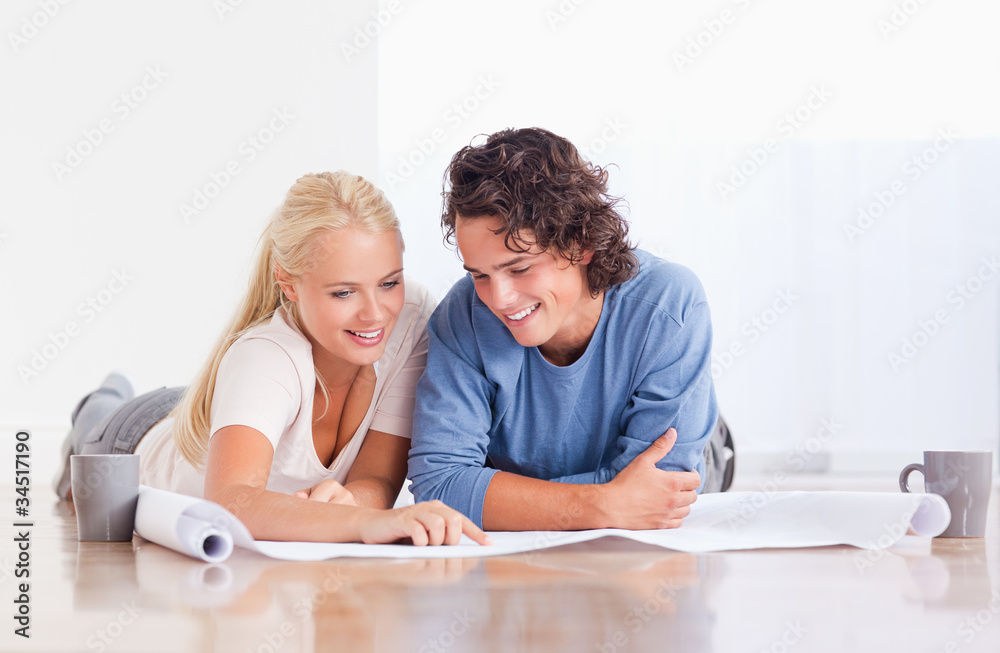 Smiling couple getting ready to move in a new house