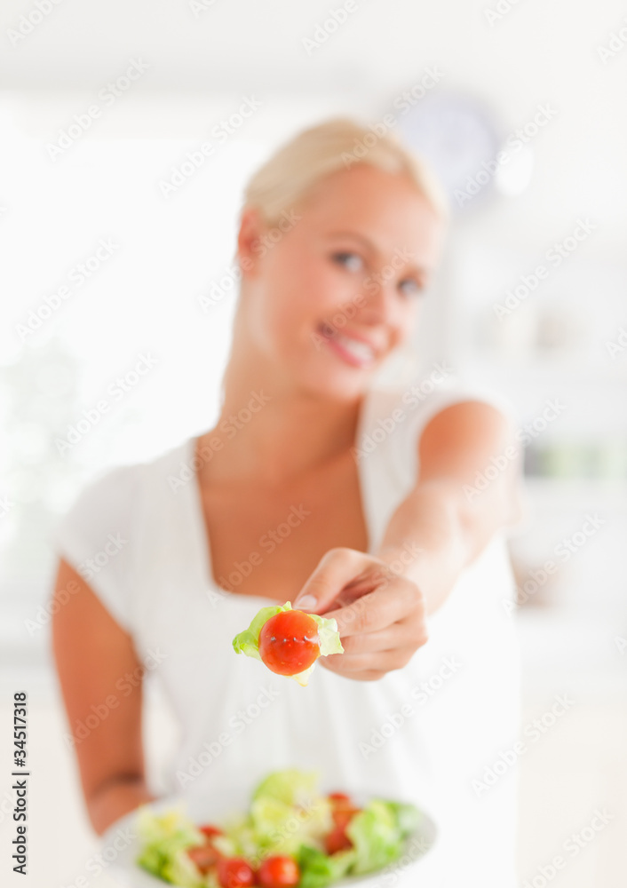 Portrait of a woman giving a tomato Portrait of a woman giving a tomato