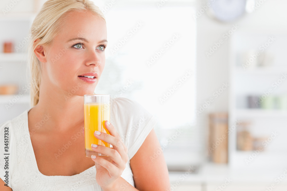 Close up of a woman drinking orange juice Close up of a woman drinking orange juice