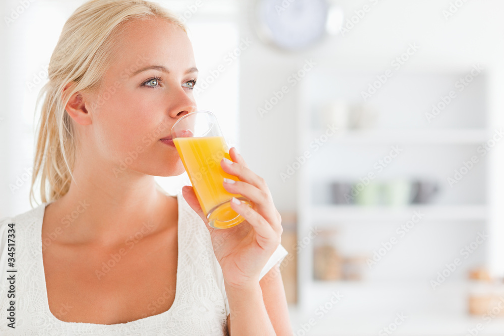 Close up of a blonde woman drinking juice Close up of a blonde woman drinking juice
