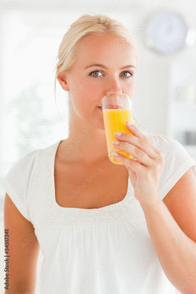 Portrait of a woman drinking orange juice Portrait of a woman drinking orange juice