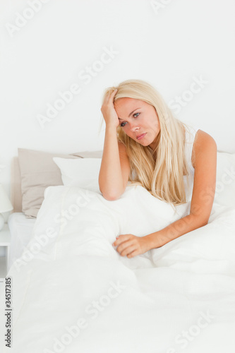 Beautiful woman sitting on her bed © WavebreakmediaMicro