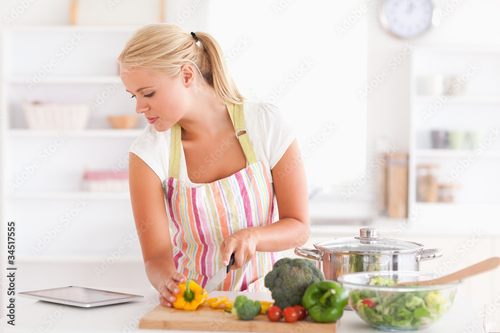 Woman using a tablet computer to cook