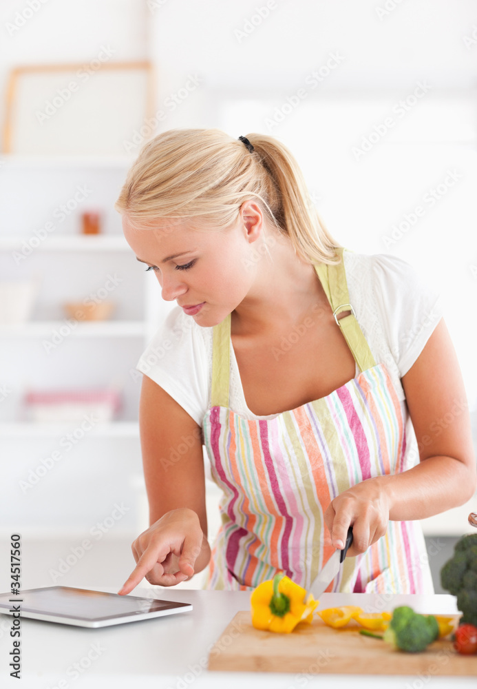 Portrait of a woman using a tablet computer to cook Portrait of a woman using a tablet computer to cook