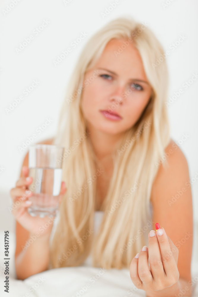 Portrait of a sick woman taking a pill Portrait of a sick woman taking a pill