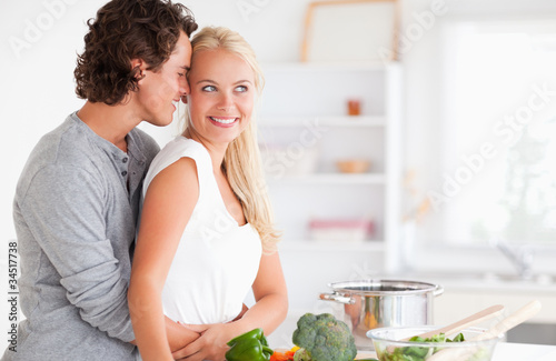 Couple hugging while cooking