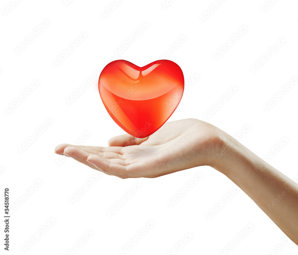Fototapeta premium Red heart on a woman's hand.Heart on the palm - love symbol