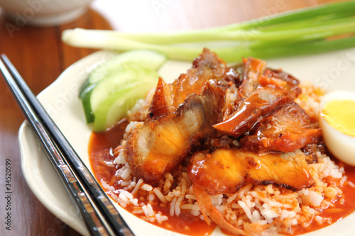 Barbecue and Crispy pork with gravy sauce on rice,Chinese food photo