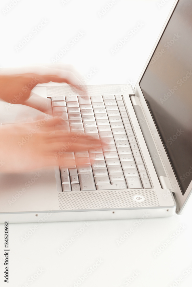 Blurred hands on keyboard