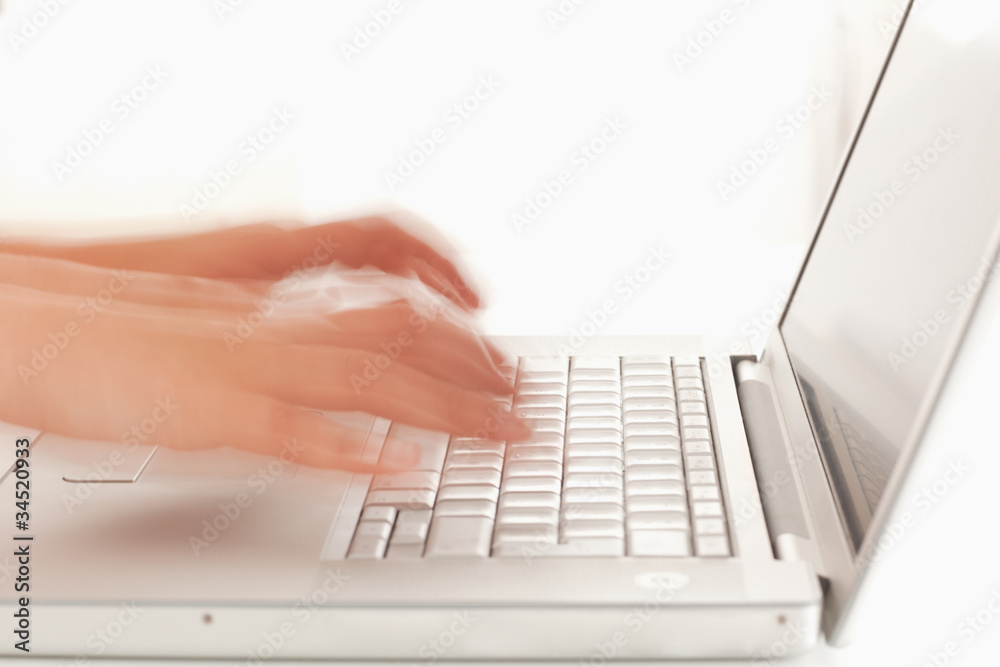 Slightly blurred hands on notebook Slightly blurred hands on notebook