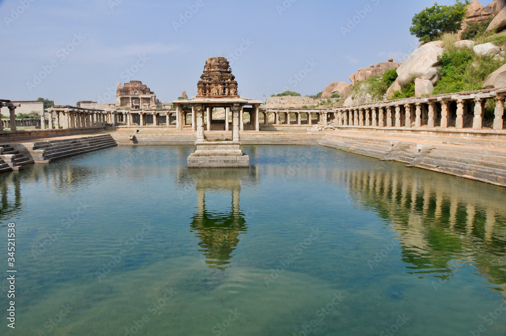 Ancient water pool and temple at Krishna market, Hampi, India