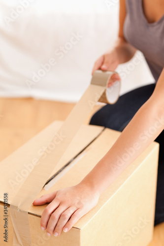 Close up of a woman preparing a cardboard