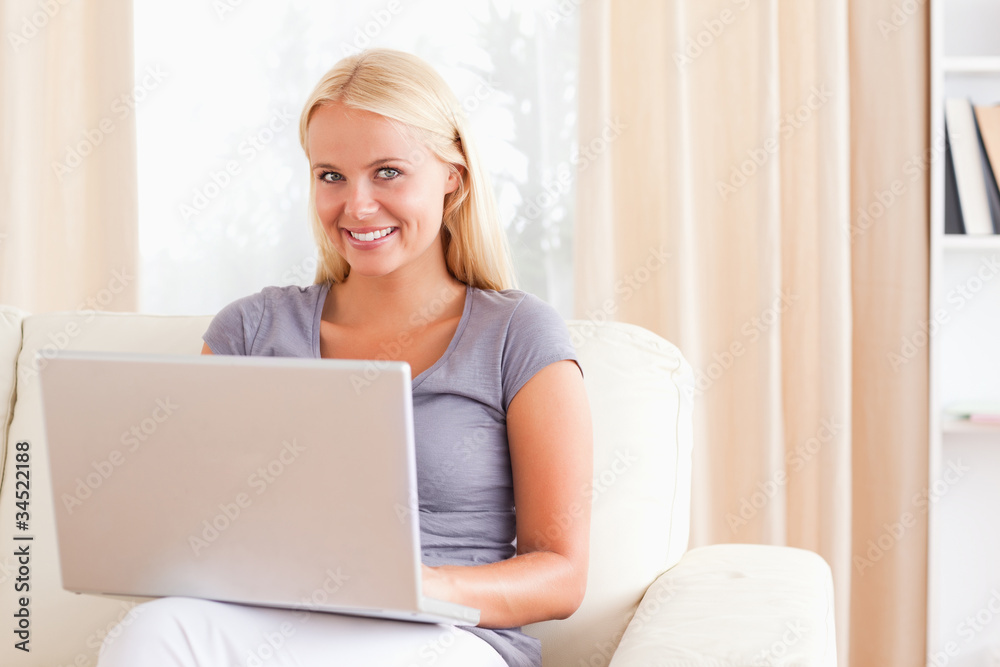 Smiling woman using a laptop Smiling woman using a laptop