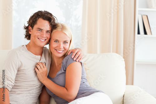 Cheerful couple sitting on a couch