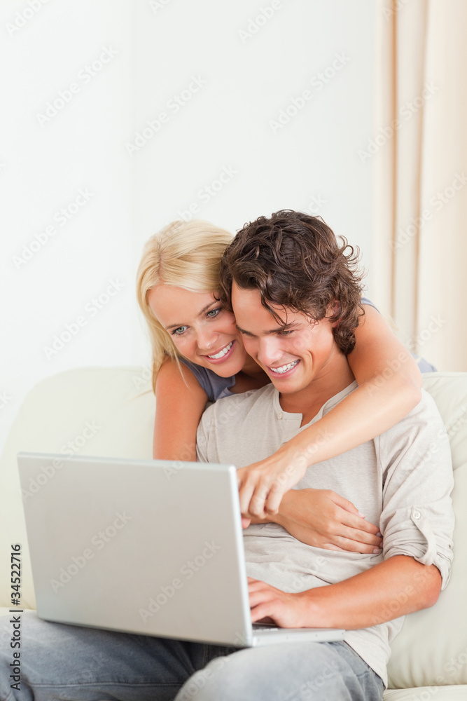 Portrait of a happy couple using a laptop