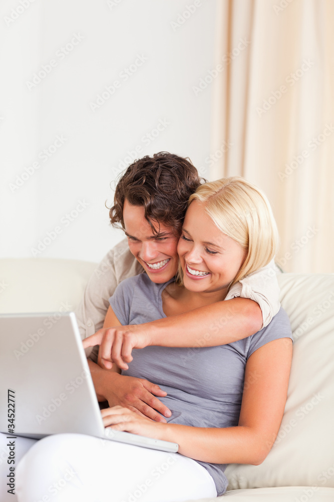 Portrait of a young couple using a notebook Portrait of a young couple using a notebook