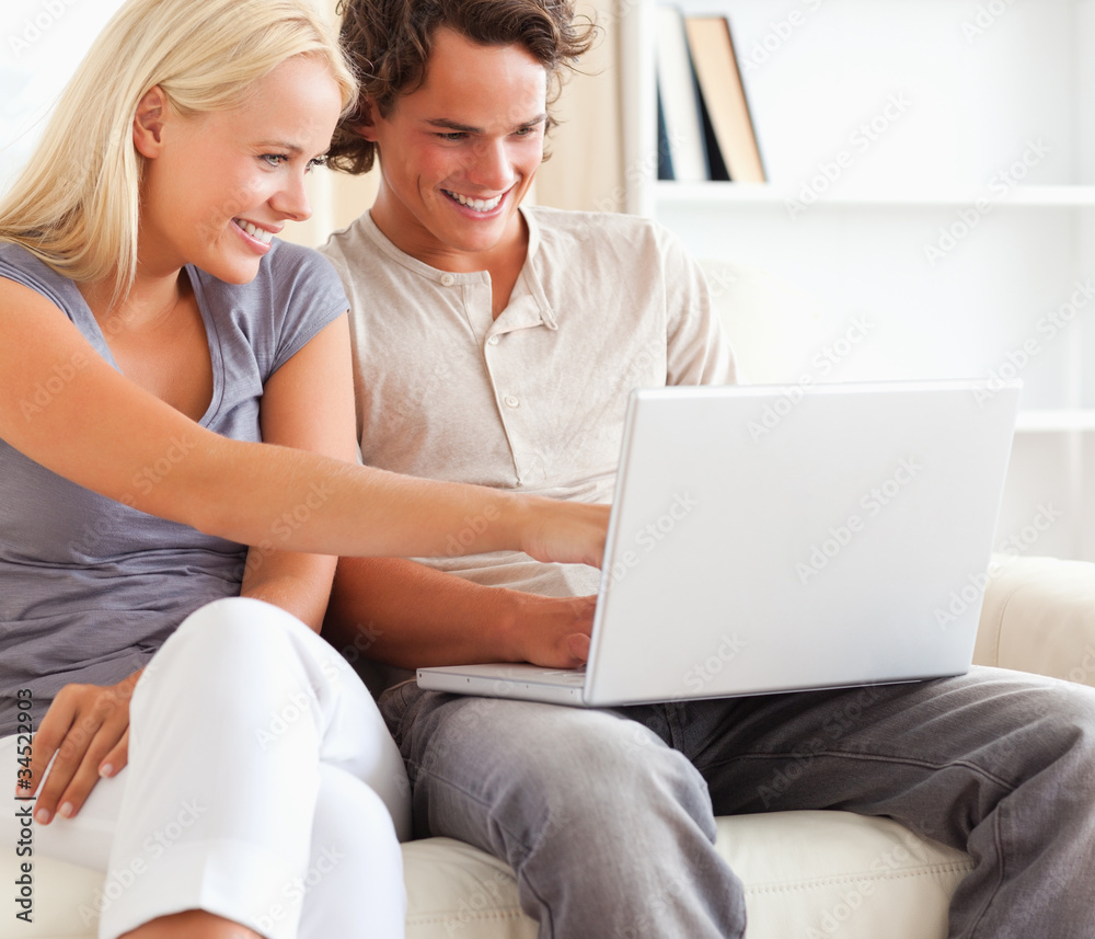 Close up of a couple using a laptop Close up of a couple using a laptop