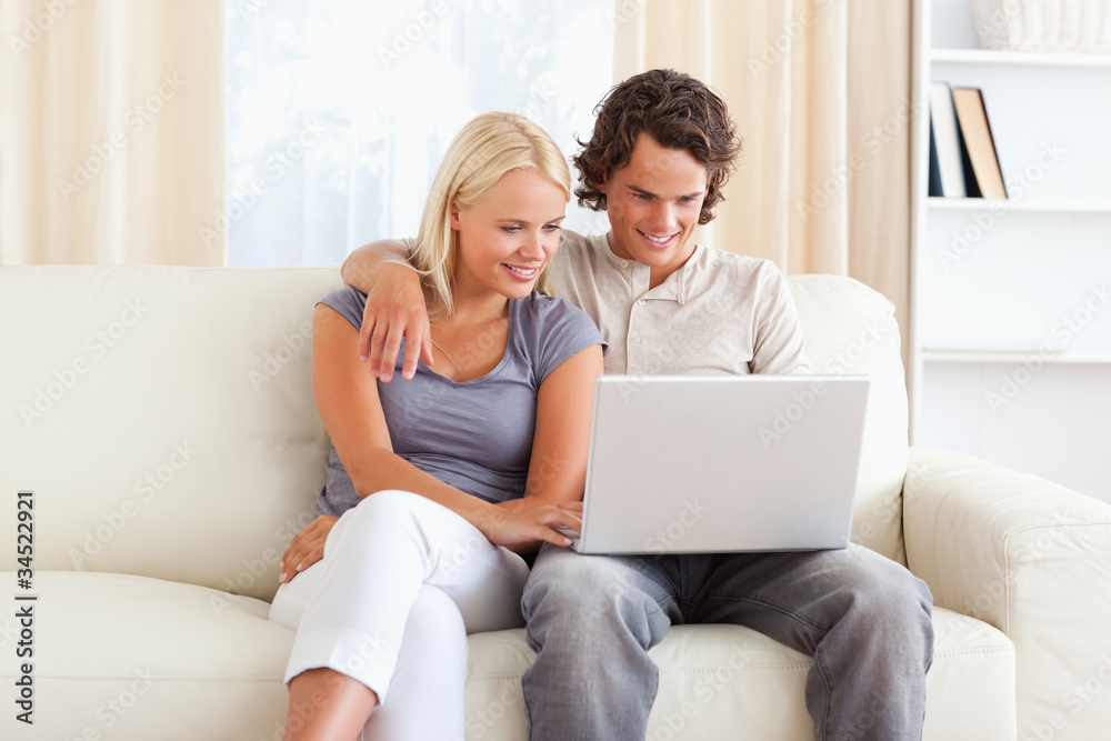 Friendly couple using a notebook Friendly couple using a notebook
