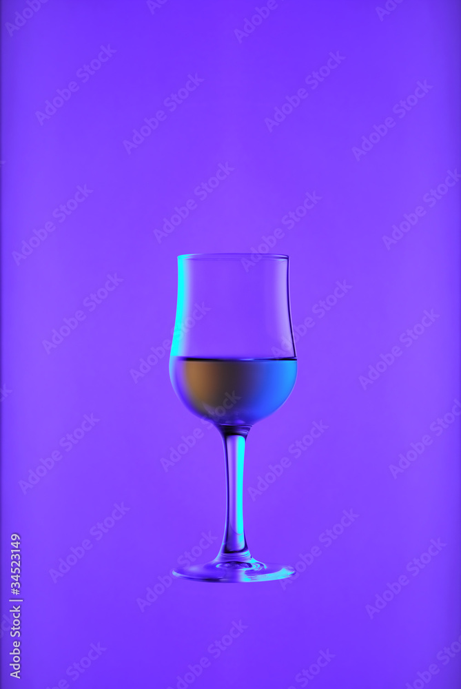 Goblet with white wine on blue
