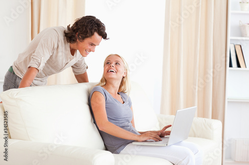 Laughing couple with a laptop