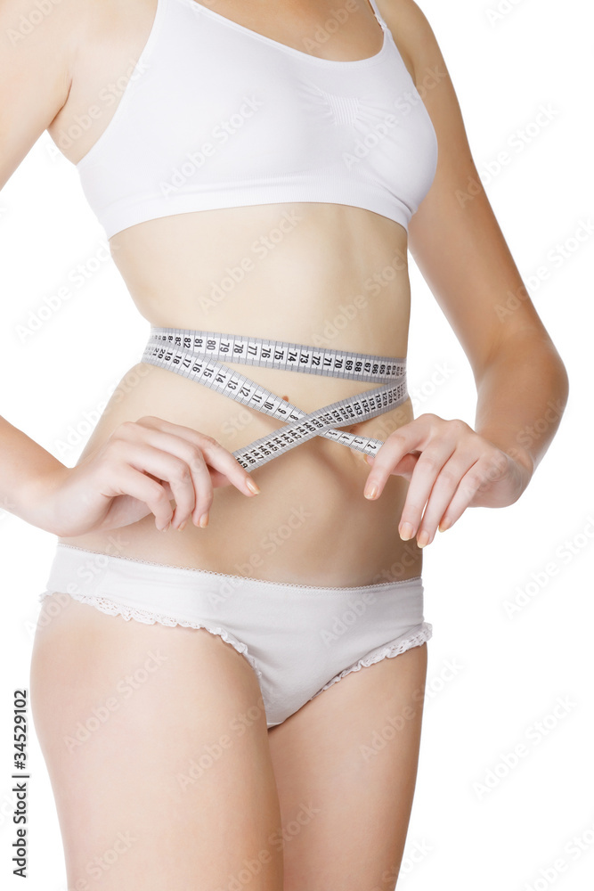 woman measuring size of her waist with a tape measure