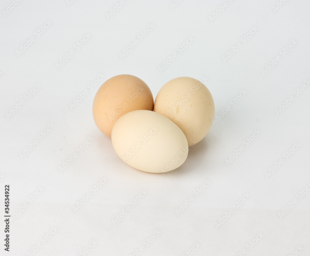 Three light brown eggs on white Three light brown eggs on white