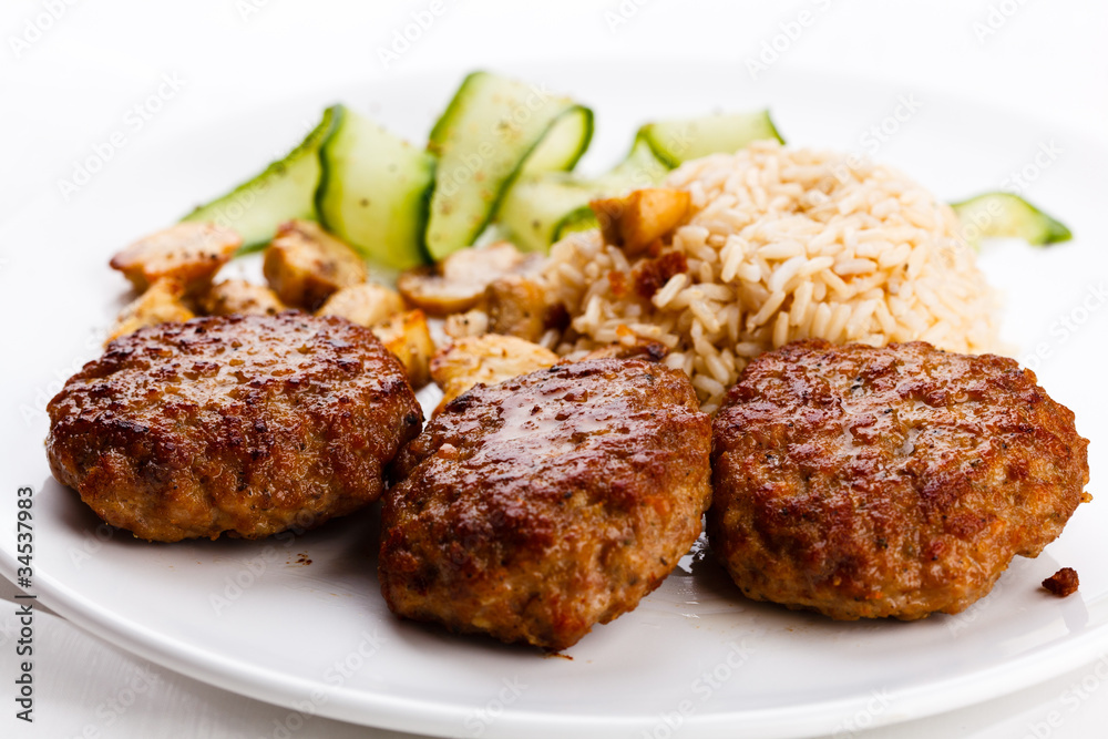 Fried steaks with rice and vegetable salad Fried steaks with rice and vegetable salad