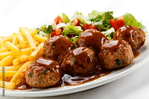 Roasted meatballs, French fries and vegetable salad