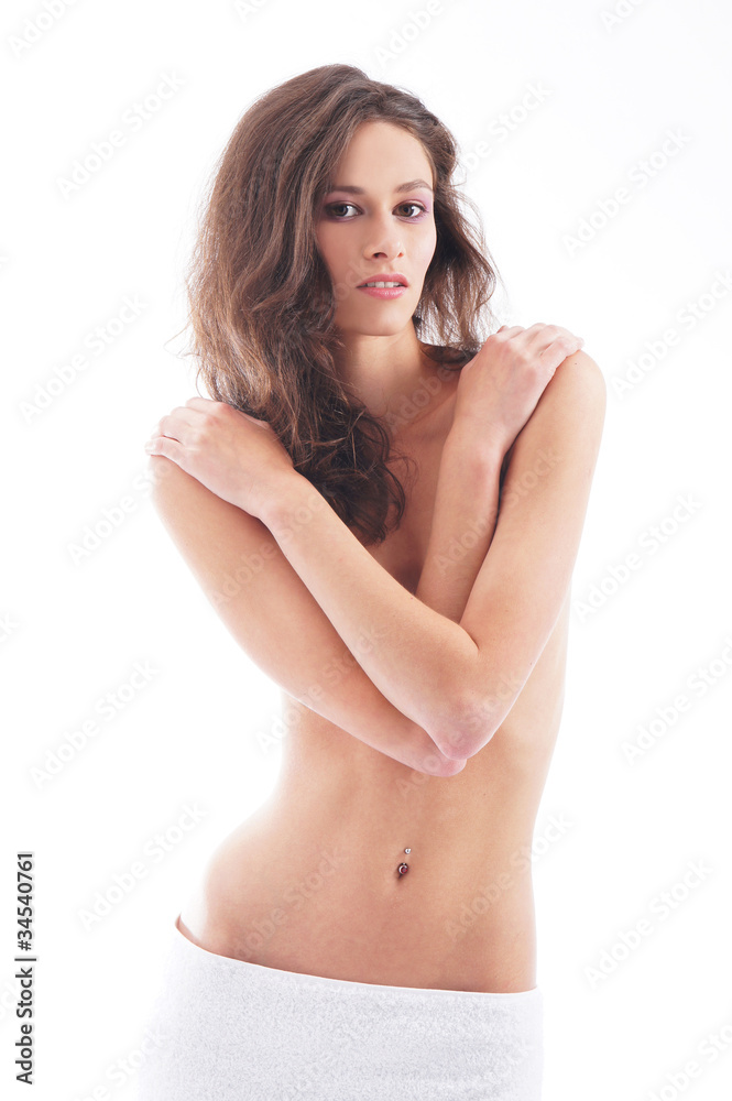 Obraz premium Young brunette in a white towel on white