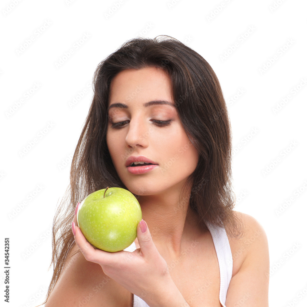 Portrait of a young brunette woman holding a fresh green apple Portrait of a young brunette woman holding a fresh green apple