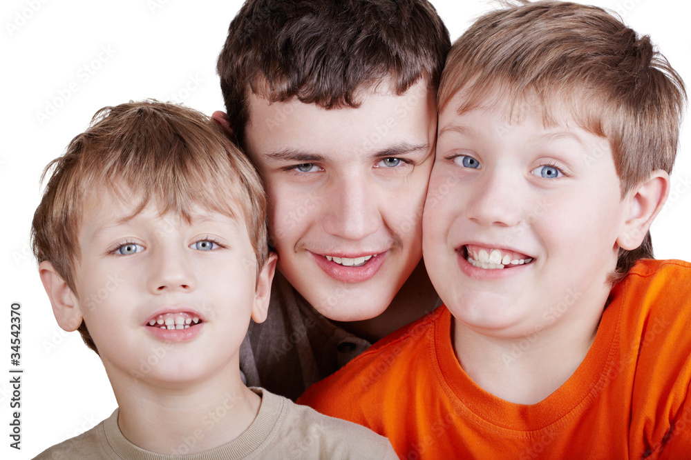 Close-up portrait of three grinning boys head to head Close-up portrait of three grinning boys head to head