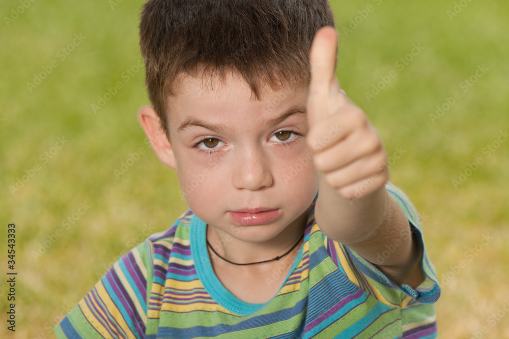 Angry boy with his thumb up Angry boy with his thumb up