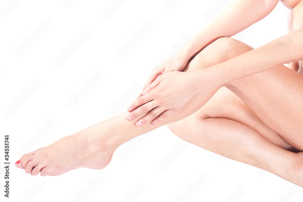 Woman massaging legs sitting on white background Woman massaging legs sitting on white background