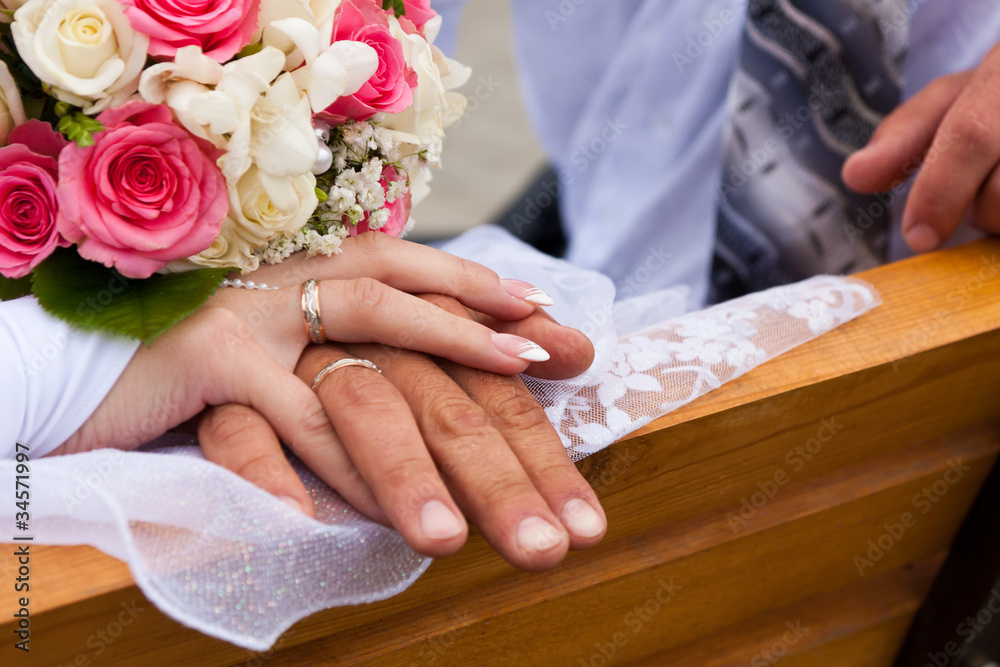Hands and rings with wedding bouquet Hands and rings with wedding bouquet