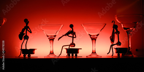 Glasses and statuettes in red light