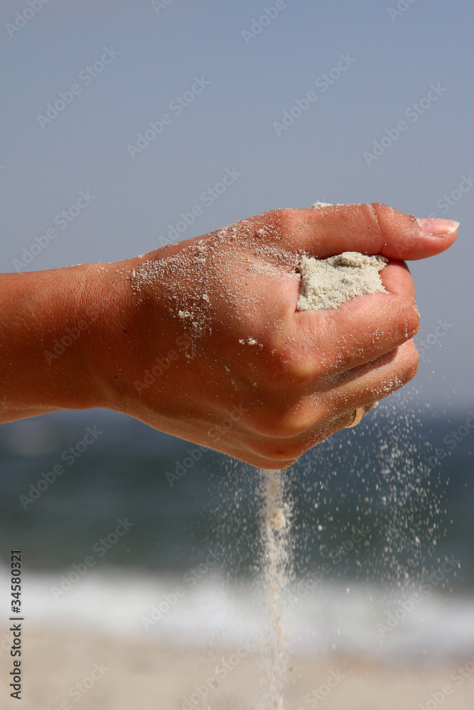 hand with the sand against the sea hand with the sand against the sea