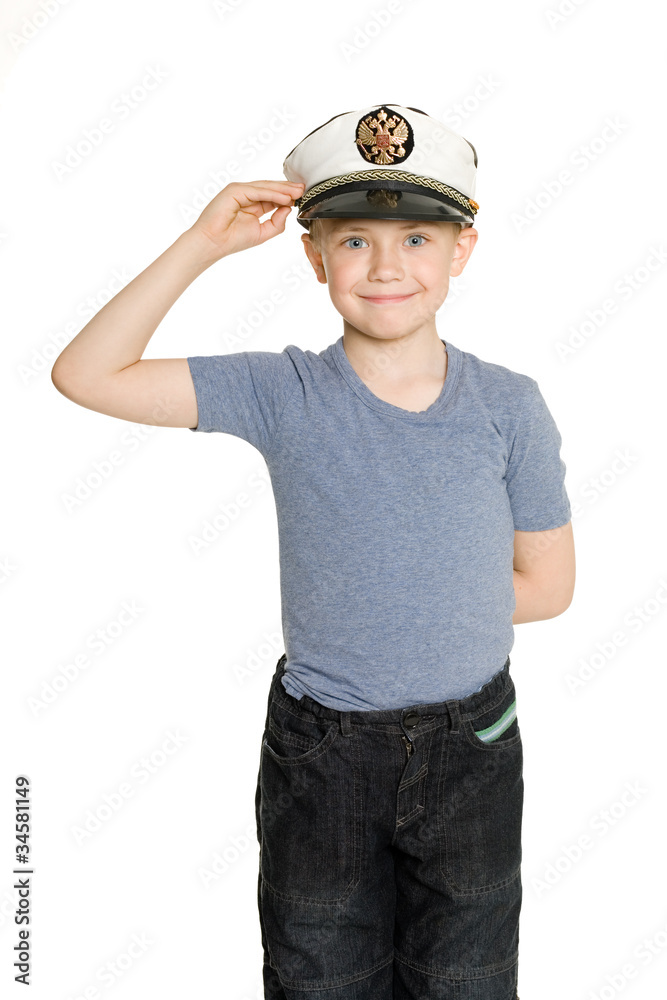 Boy in the sea cap salutes. His cap emblem of Russia.