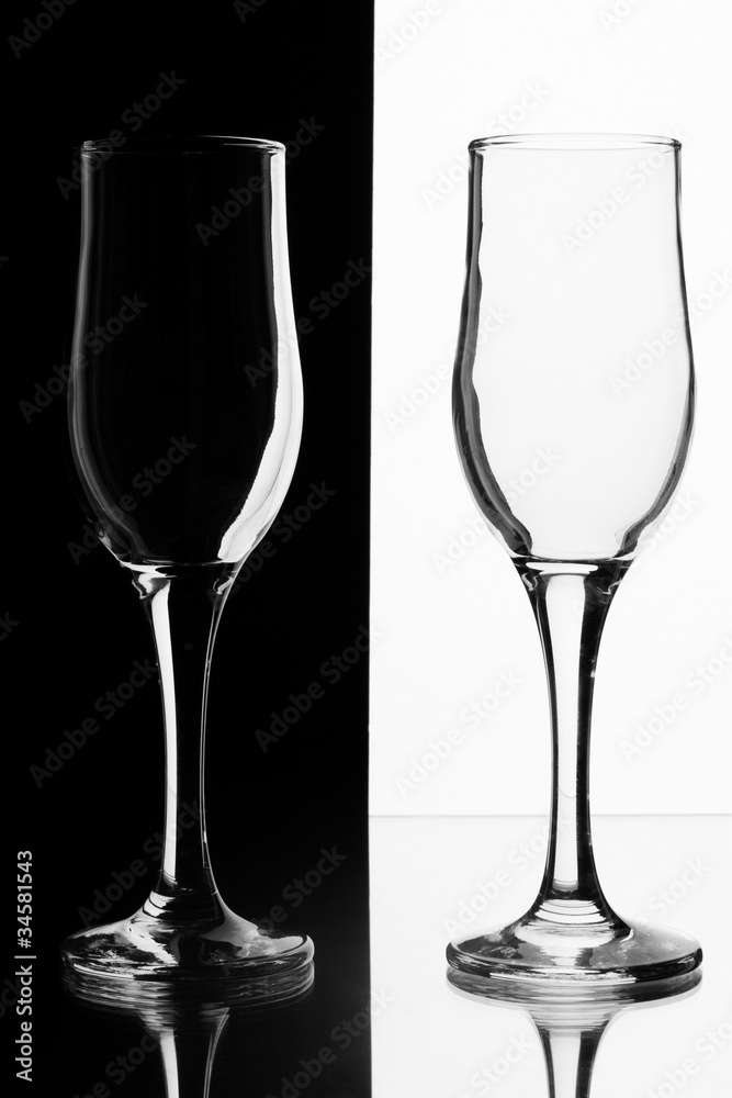 Two glasses on a black and white.