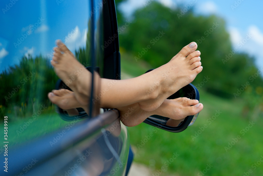 woman feet out of car window