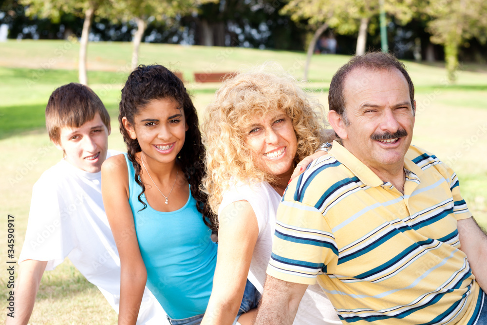 Portrait of family relaxing in park Portrait of family relaxing in park