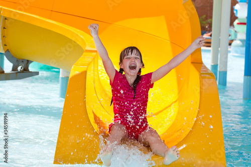 Happy girl on waterslide photo