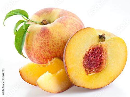 Ripe peach fruit with leaves and slises